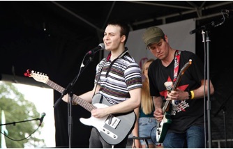 Josef Pitura-Riley performing with his band on the Village Green stage at Lambeth County Festival.