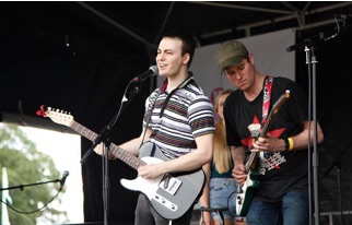 Josef Pitura-Riley performing with his band on the Village Green stage at Lambeth County Festival.